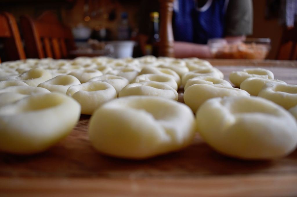 Dumplings lined on a pastry board